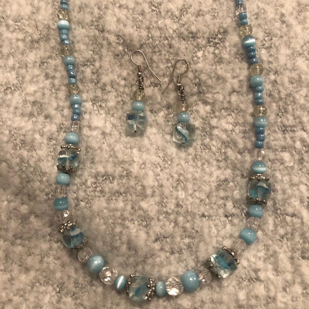 Handmade beaded necklace with extender and matching earrings.